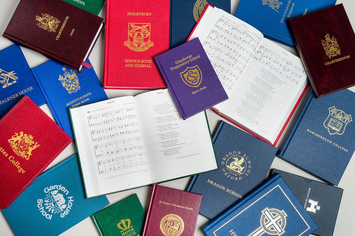 A spread of bespoke hymn books and school publications produced by Gresham Books